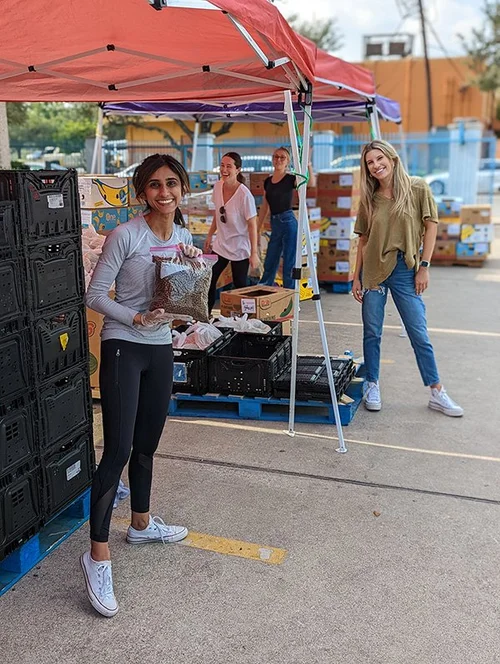 Volunteers organizing food donations at an outdoor Austin community distribution