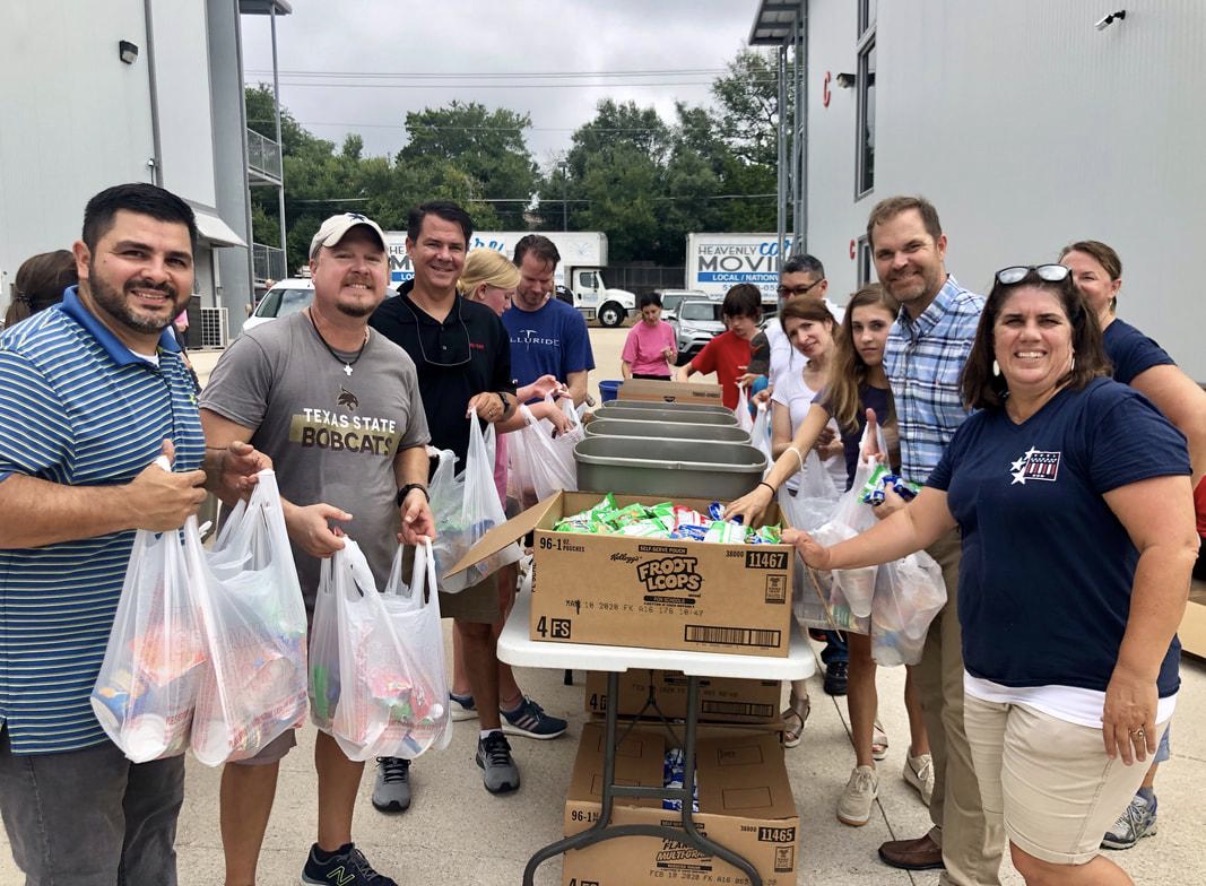 Community volunteers preparing bags of donated food together